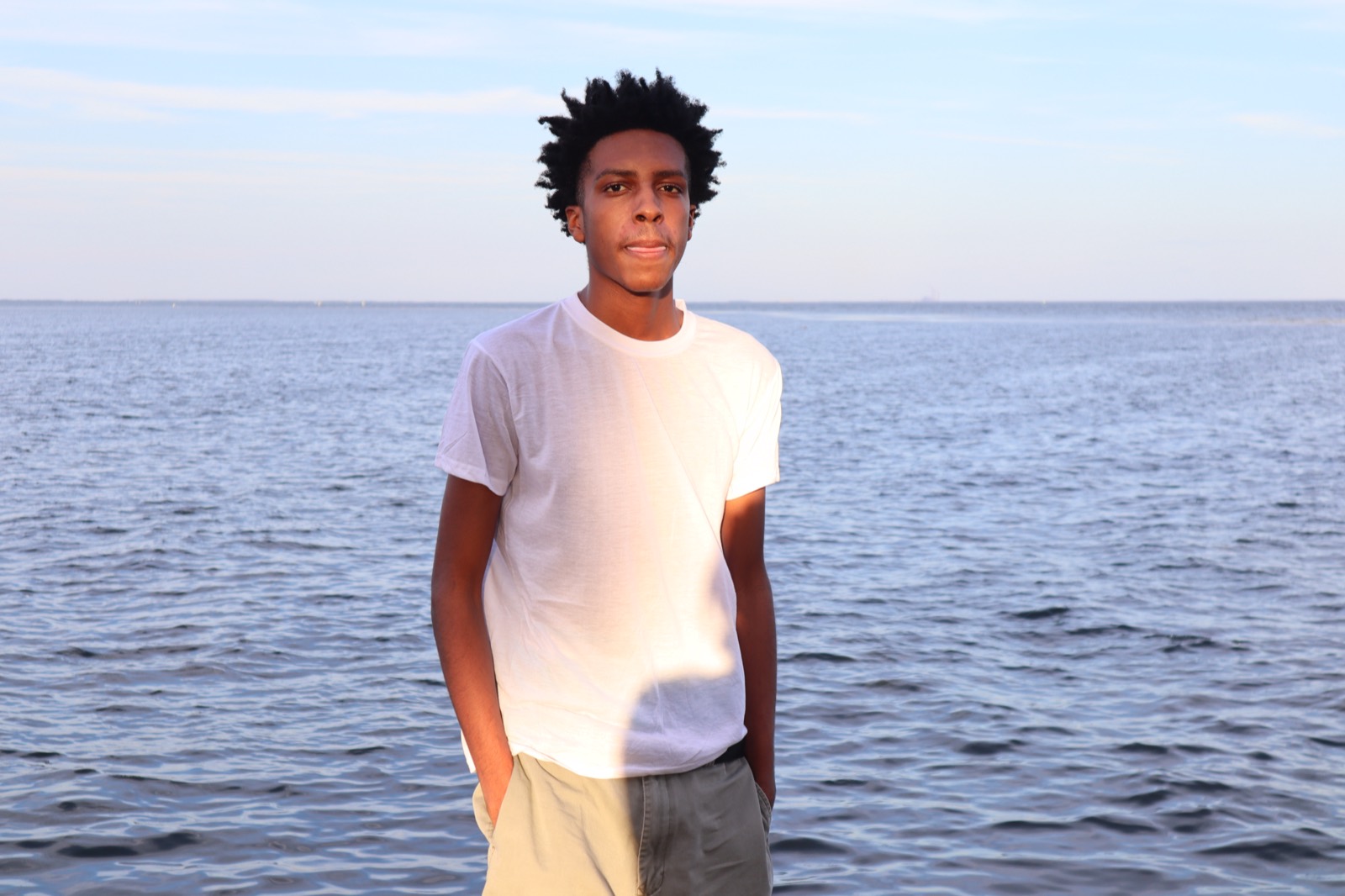 Tampa waterfront senior portrait of a young man in a white t-shirt